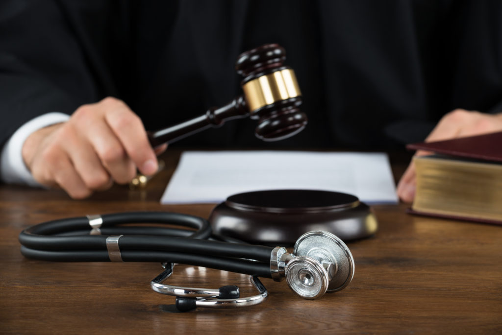 What’s A Strong Medical Malpractice Claim? - Judge Striking Mallet With Stethoscope At Desk